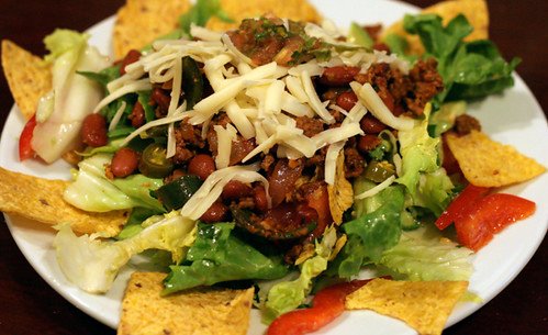 High protein taco salad bowl with lettuce beans cheese and tortilla chips