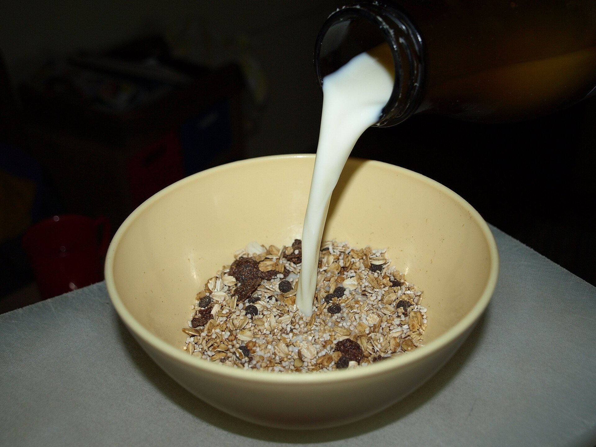 Overnight oats or muesli being mixed with milk in a bowl