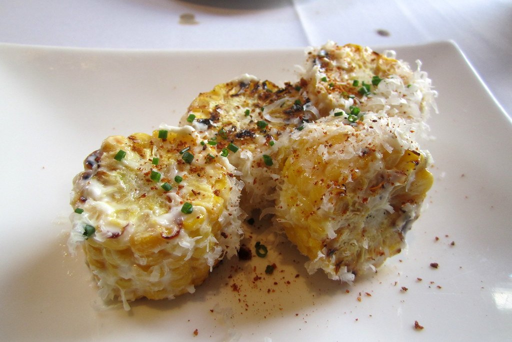 High-protein cottage cheese street corn dip with corn, lime, chili, and vegetables