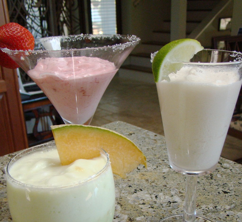 Three creamy dessert cups representing high-protein dessert recipes